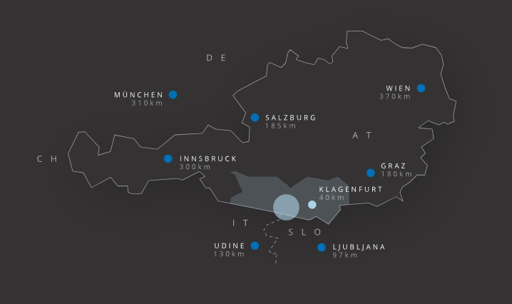 Offizielle Visit-Villach-Anreisekarte mit Österreich, hervorgehobenem Kärnten und Entfernungen zu Städten im Alpen-Adria-Raum
